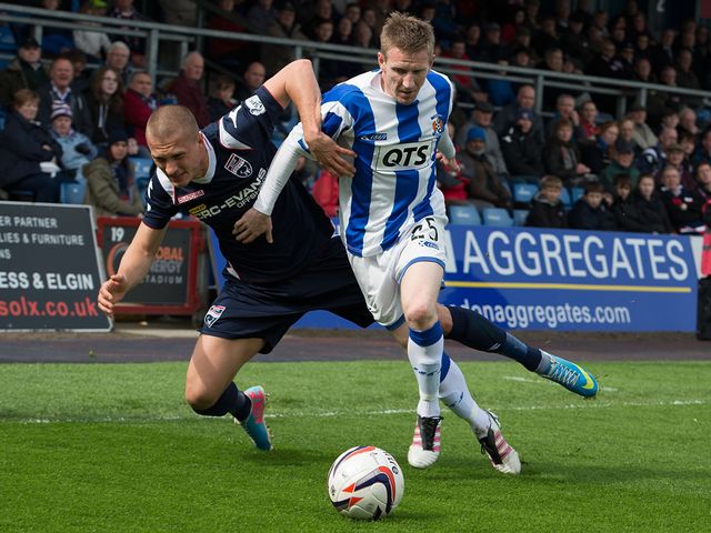 Ross county's Erik Cikos goes up against Michael Gardyne