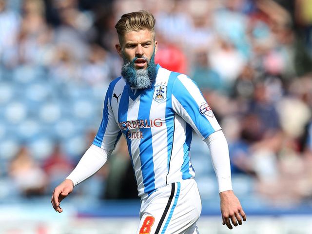 Huddersfield Town's Adam Clayton with a blue and white beard during their clash with Leicester