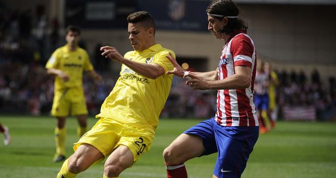 Gabriel Paulista and Filipe Luis compete for the ball