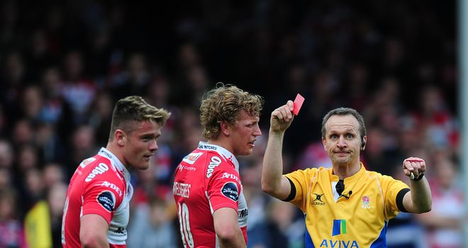 Tavis Knoyle of Gloucester (L) receives a red card from referee Tim Wigglesworth