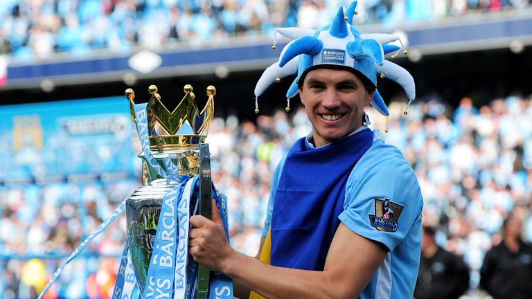 Edin Dzeko poses with the Premier League trophy in 2012