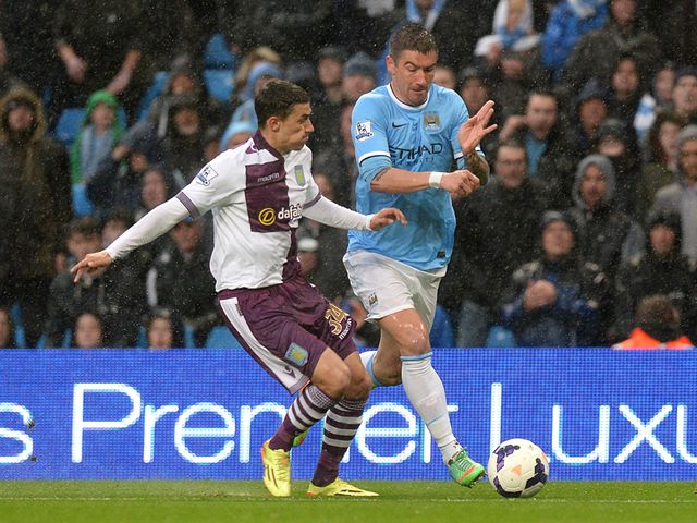 Matthew Lowton and Aleksandar Kolarov tussle for possession
