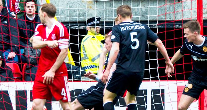 Craig Reid scrambles in the late winner for Motherwell at Aberdeen