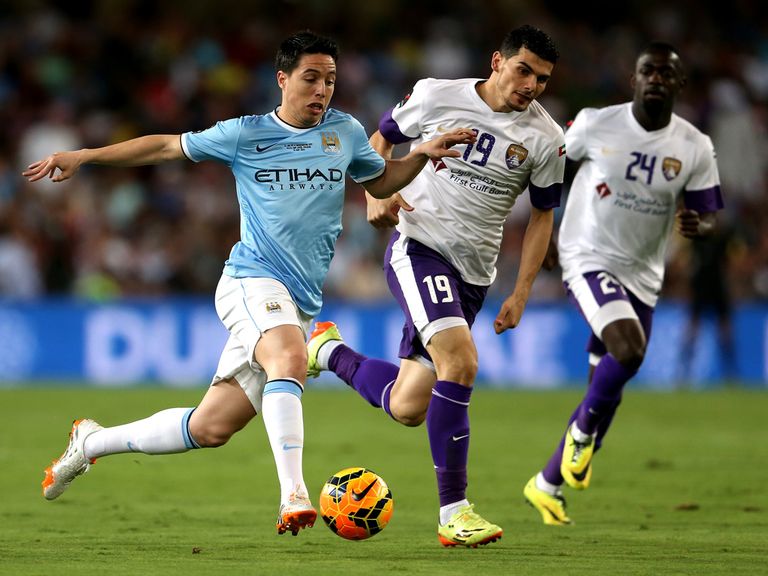 Samir Nasri tries to shake off two defenders