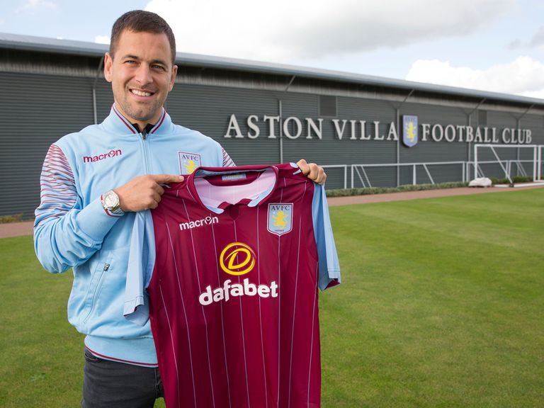 Joe Cole poses with an Aston Villa shirt after signing two-year deal