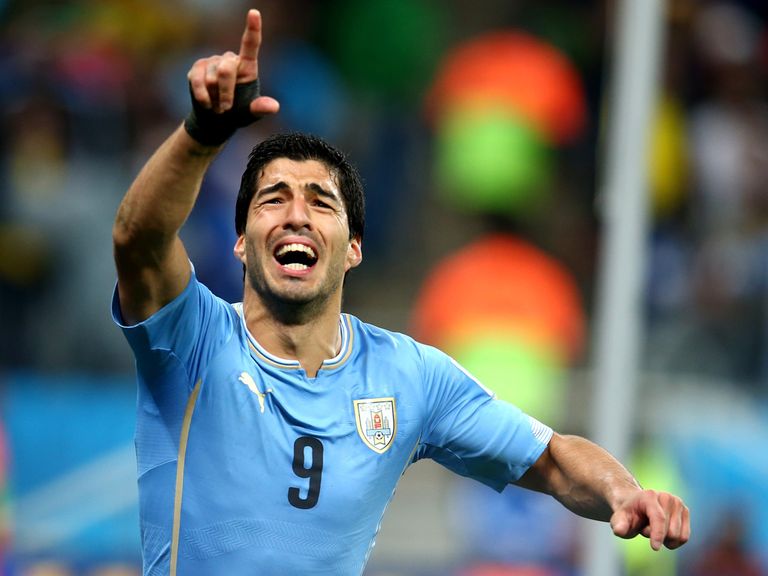 Luis Suarez celebrates after scoring against England