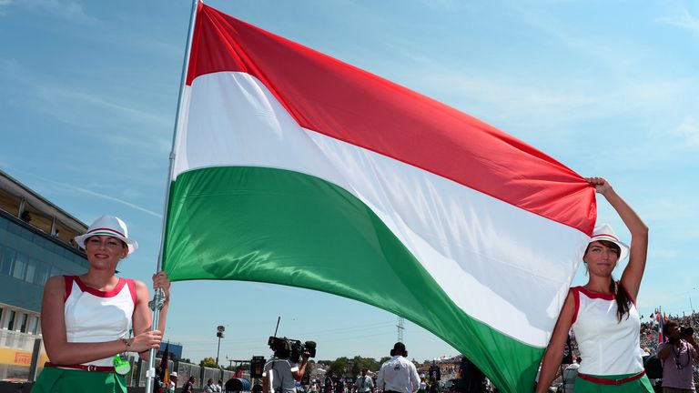 Grid girls with a Hungarian flag