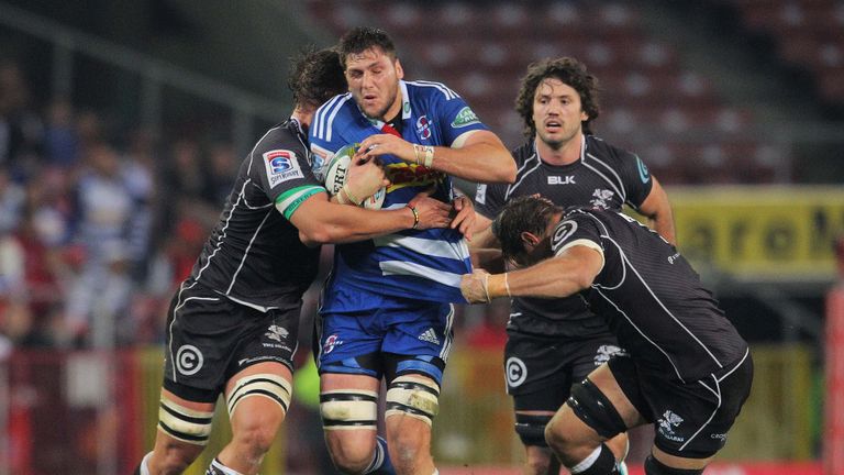 The Sharks defence gang-tackles Ruan Botha