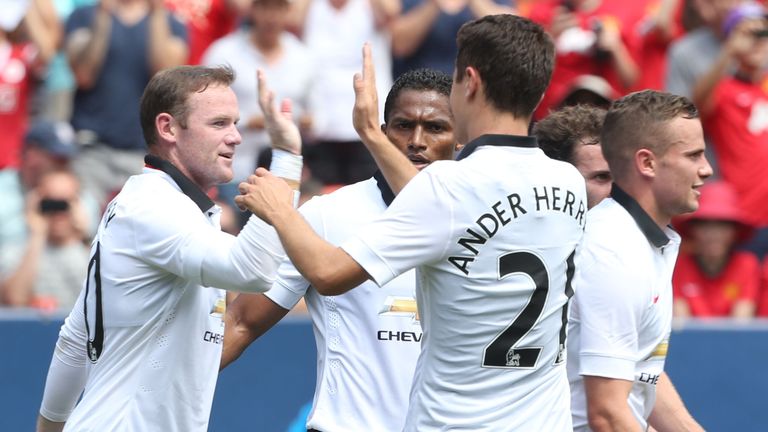Wayne Rooney: Celebrates after scoring United's third against Roma