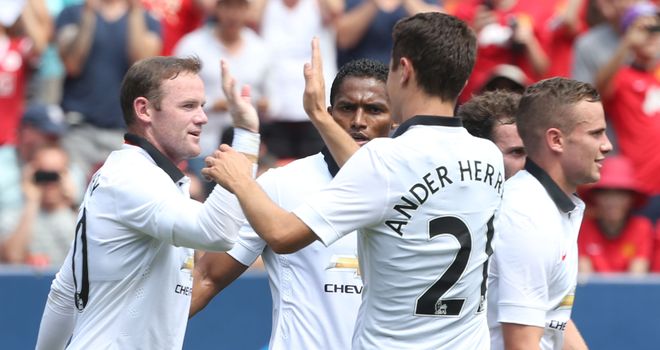Wayne Rooney: Celebrates after scoring United's third against Roma