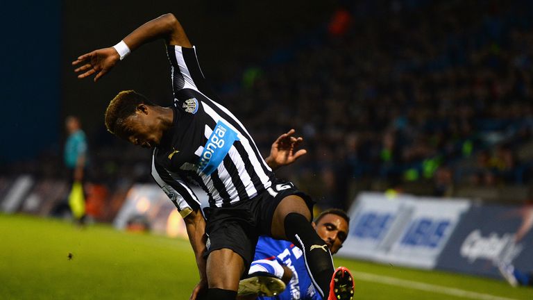 Leon Legge of Gillingham tackles Rolando Aarons of Newcastle United