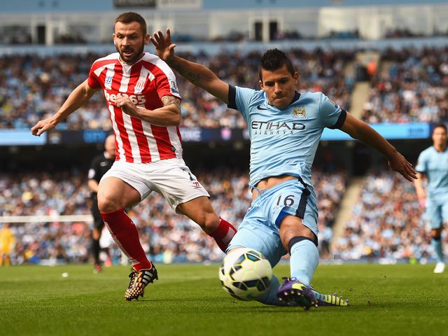 Sergio Aguero of Manchester City shoots under pressure from Phil Bardsley