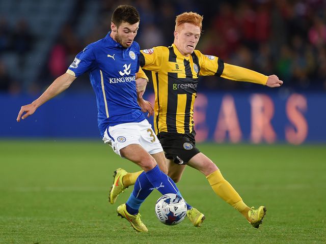 Michael Cain of Leicester (left) in action with Ryan Woods of Shrewsbury