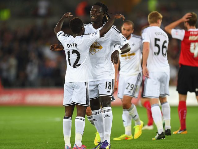 Swansea's Nathan Dyer (left) celebrates with goalscorer Bafetimbi Gomis