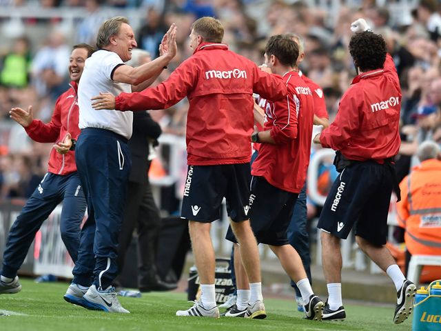Neil Warnock celebrates with the Crystal Palace staff at full-time
