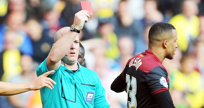 Referee Simon Hooper dismisses Norwich defender Martin Olsson at Molineux