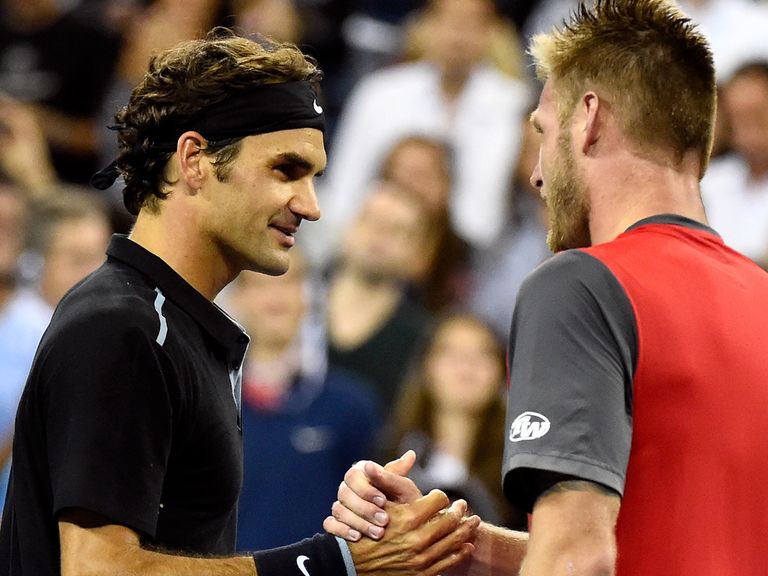 Roger Federer of Switzerland shakes hands with Sam Groth of Australia