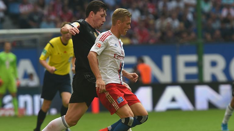 Pierre Emile Hojbjerg of Bayern challenges for the ball with Matthais Ostrzolek