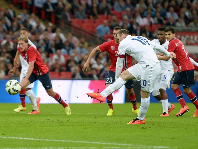 England's Wayne Rooney scores the only goal from the penalty spot