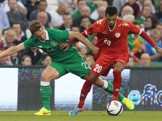Republic of Ireland's Kevin Doyle and Oman's Mohammed Al-Siyabi (right) in action