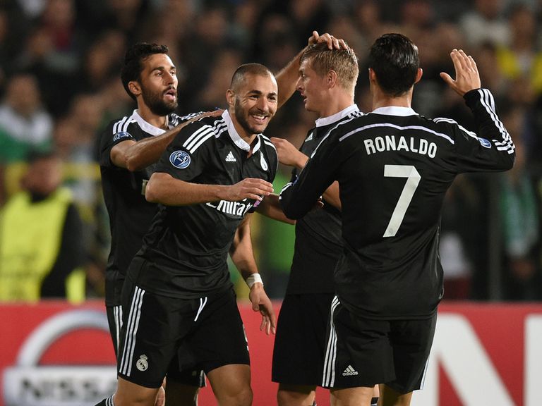 Real Madrid's Karim Benzema  is congratulated by teammates