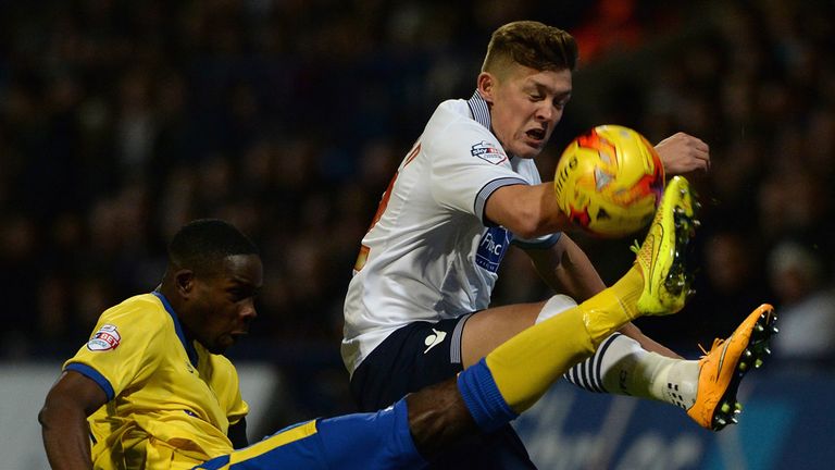 Max Clayton of Bolton Wanderers is tackled by Leon Barnett