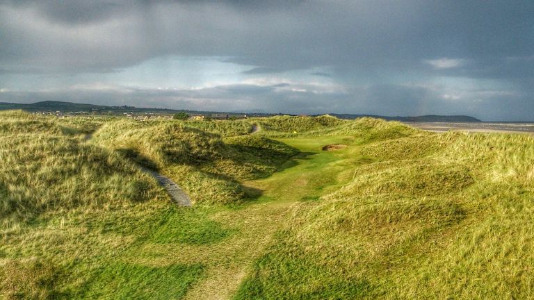 The par-three 17th green sits amongst the sand hills