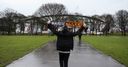 A fan holds his scarf aloft as he walks to the KC Stadium prior to the Barclays Premier League match between Hull City and Newcastle