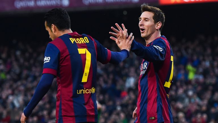Lionel Messi celebrates with Pedro after a Barcelona goal