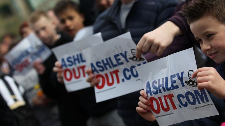 A large group of Newcastle fans protest against the owner