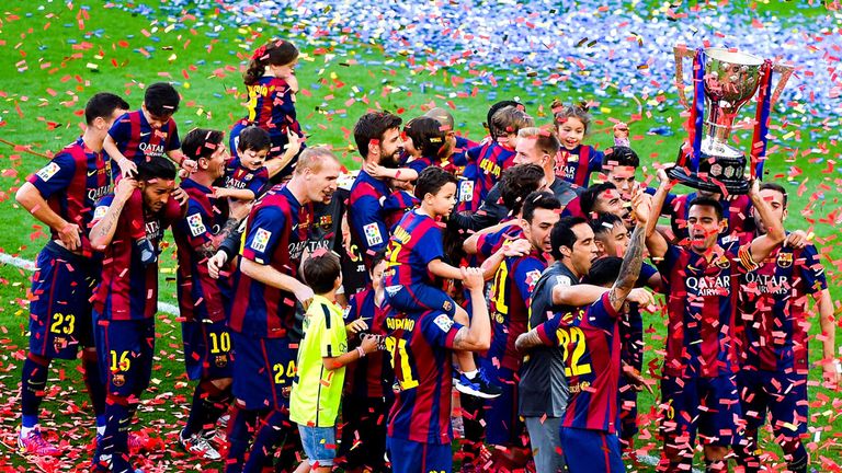Barcelona players celebrate with the La Liga trophy, having pipped Real Madrid by two points