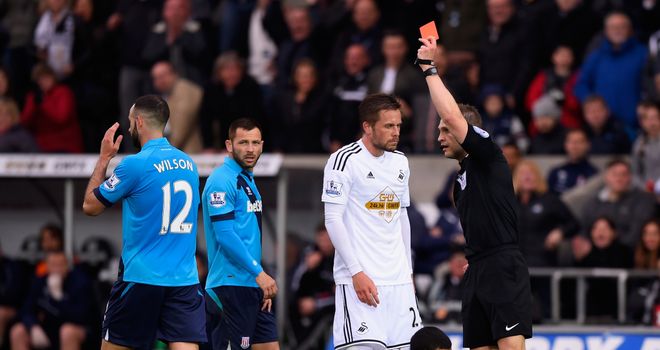 Marc Wilson of Stoke City is shown the red card by referee Craig Pawson