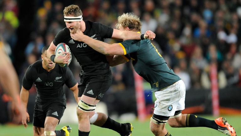 Kieran Read looks to offload as he is tackled by Schalk Burger