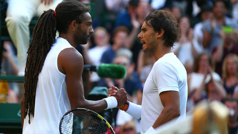 Two-time previous winner Nadal shakes hands with Brown at the net