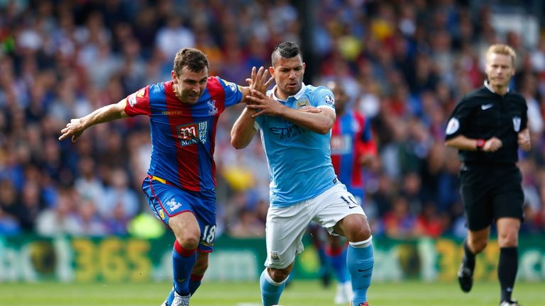 James McArthur of Crystal Palace is challenged by Aguero of Manchester City
