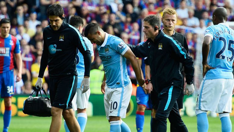 Aguero limps off the pitch after picking up an injury in the first half