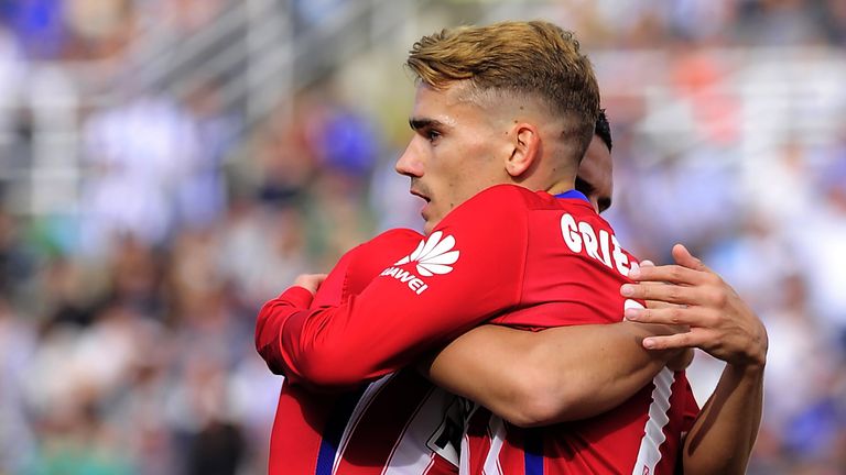 Antoine Griezmann is congratulated by Koke after opening the scoring against Sociedad