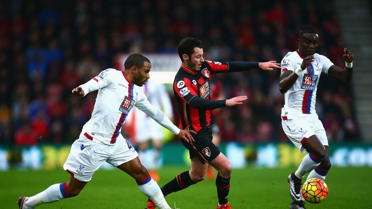 Adam Smith challenges Pape Souare (R) and Jason Puncheon of Crystal Palace