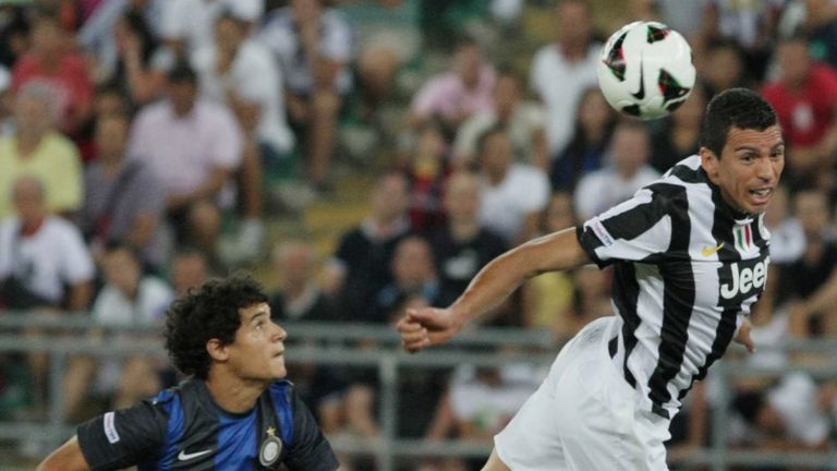 Coutinho looks on as friend Lucio (right) beats him to the ball