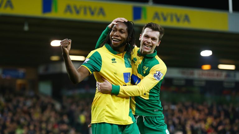 Dieumerci Mbokani (left) celebrates Norwich's second against Aston Villa