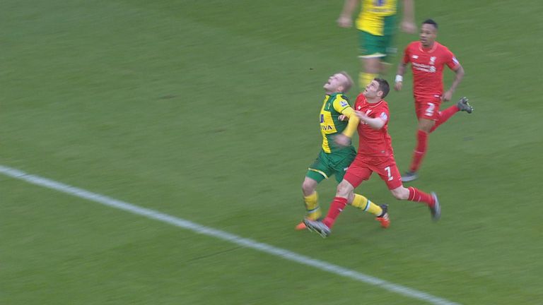 James Milner makes contact with Norwich forward Steven Naismith