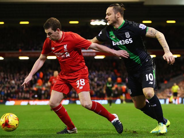 Jon Flanagan of Liverpool holds off Stoke's Marko Arnautovic 