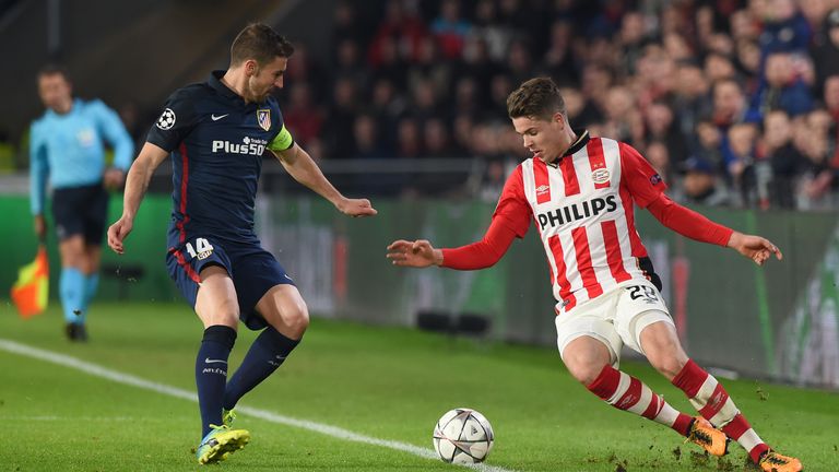 Atletico Madrid's midfielder Gabi (L) fights for the ball against PSV Eindhoven's midfielder Marco van Ginkel