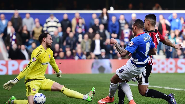 David Button of Brentford saves a shot from QPR's Tjaronn Chery