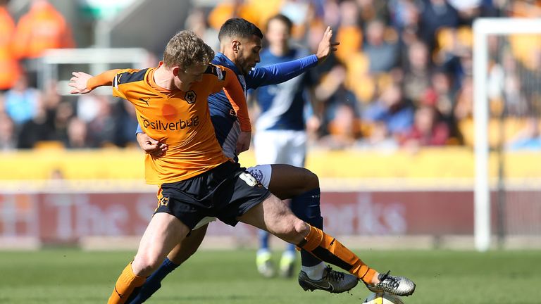 Birmingham's David Davis and Wolves' George Saville (left) battle