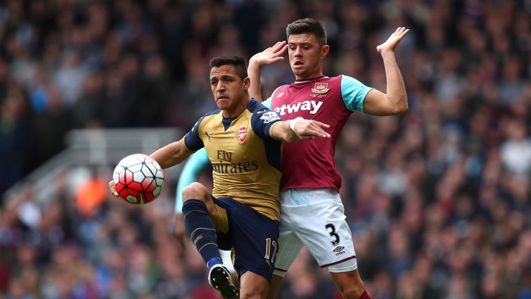 Alexis Sanchez  controls the ball under pressure from Aaron Cresswell 