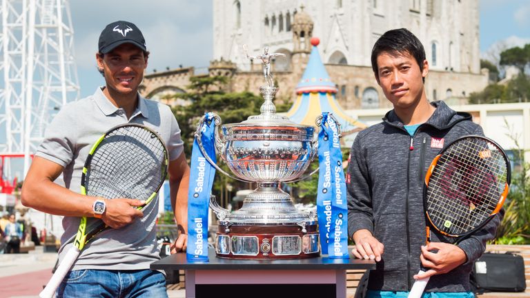 Rafael Nadal (left) and Kei Nishikori pose with the trophy
