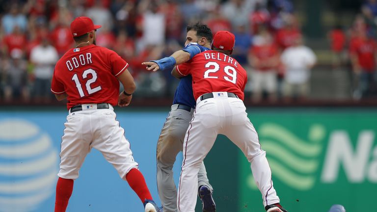 Jose Bautista (middle) was punched by Rougned Odor (left) to spark a brawl during Sunday's game