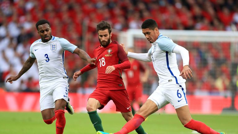 England's Danny Rose and Chris Smalling (right) battle for the ball against Portugal