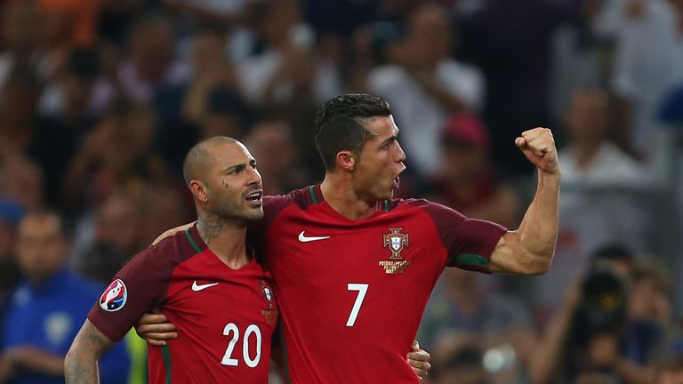 Ricardo Quaresma (L) and Cristiano Ronaldo (R) celebrate after the former scored the winning penalty for Portugal